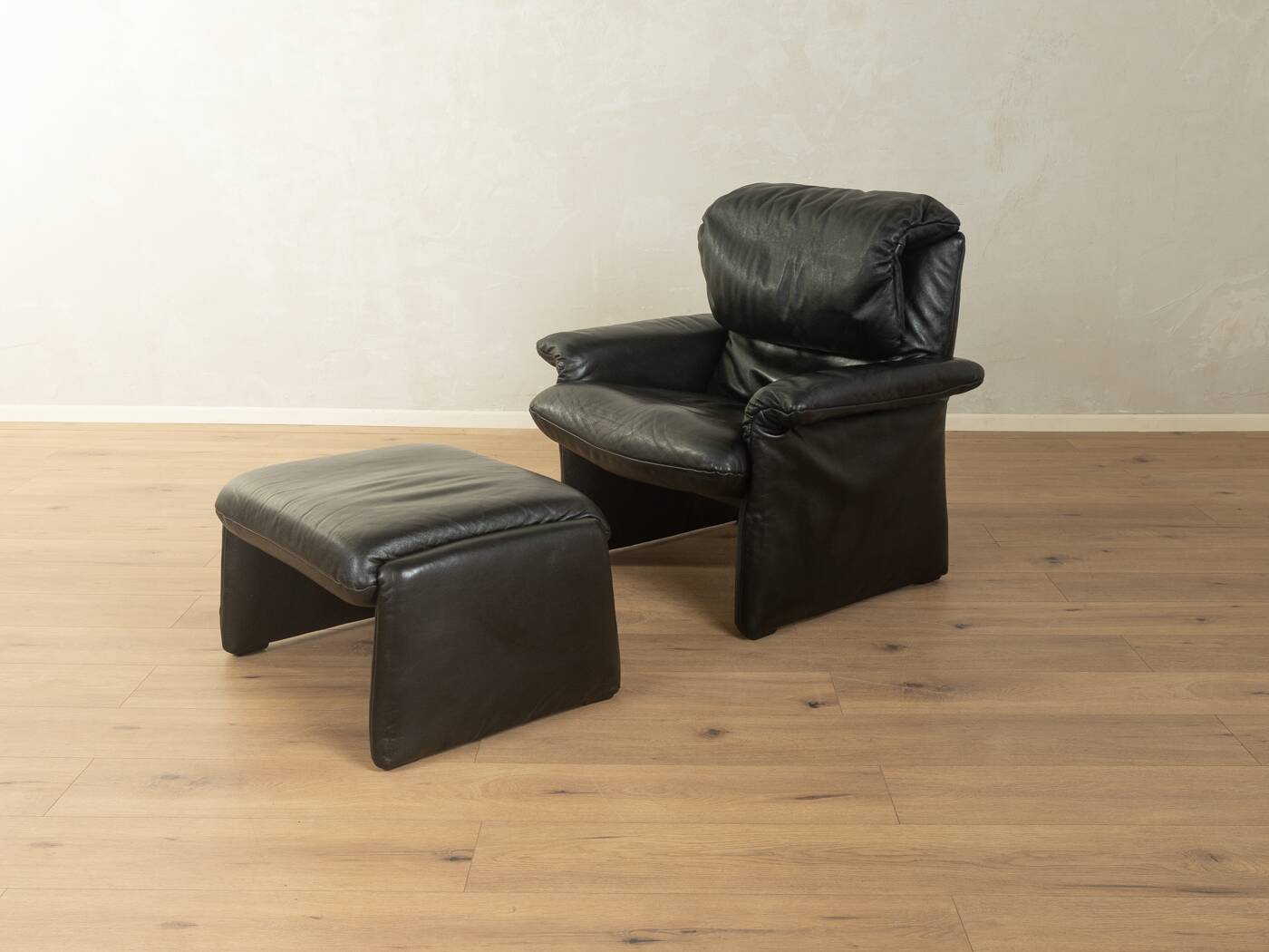 1980s cor armchair and ottoman in black leather
