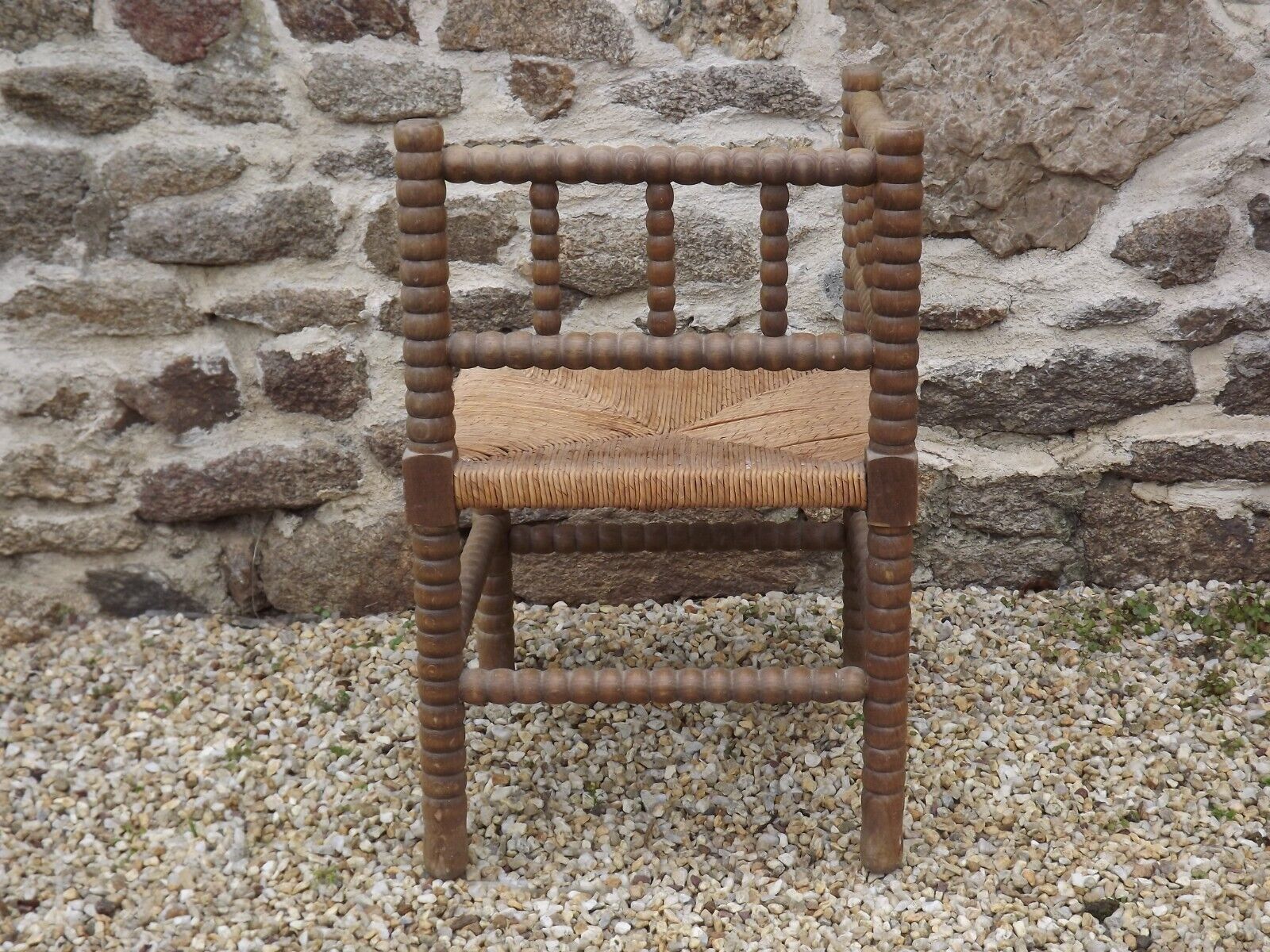 French antique turned wooden bobbin chair with rush seat