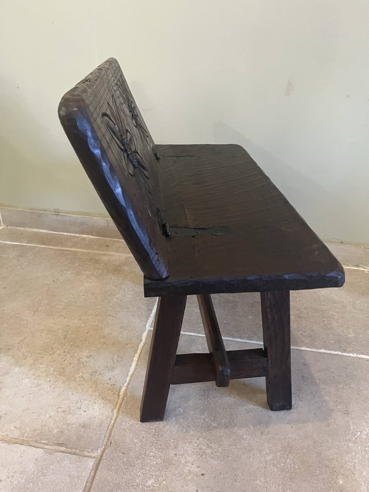 Small antique wooden bench with a folding backrest.