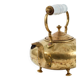Victorian tripod kettle made of brass with a porcelain handle.