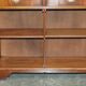 Vintage mahogany buffet with three drawers and shelves.