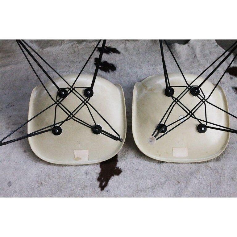 Pair of vintage Charles Eames eggshell and fiberglass chairs