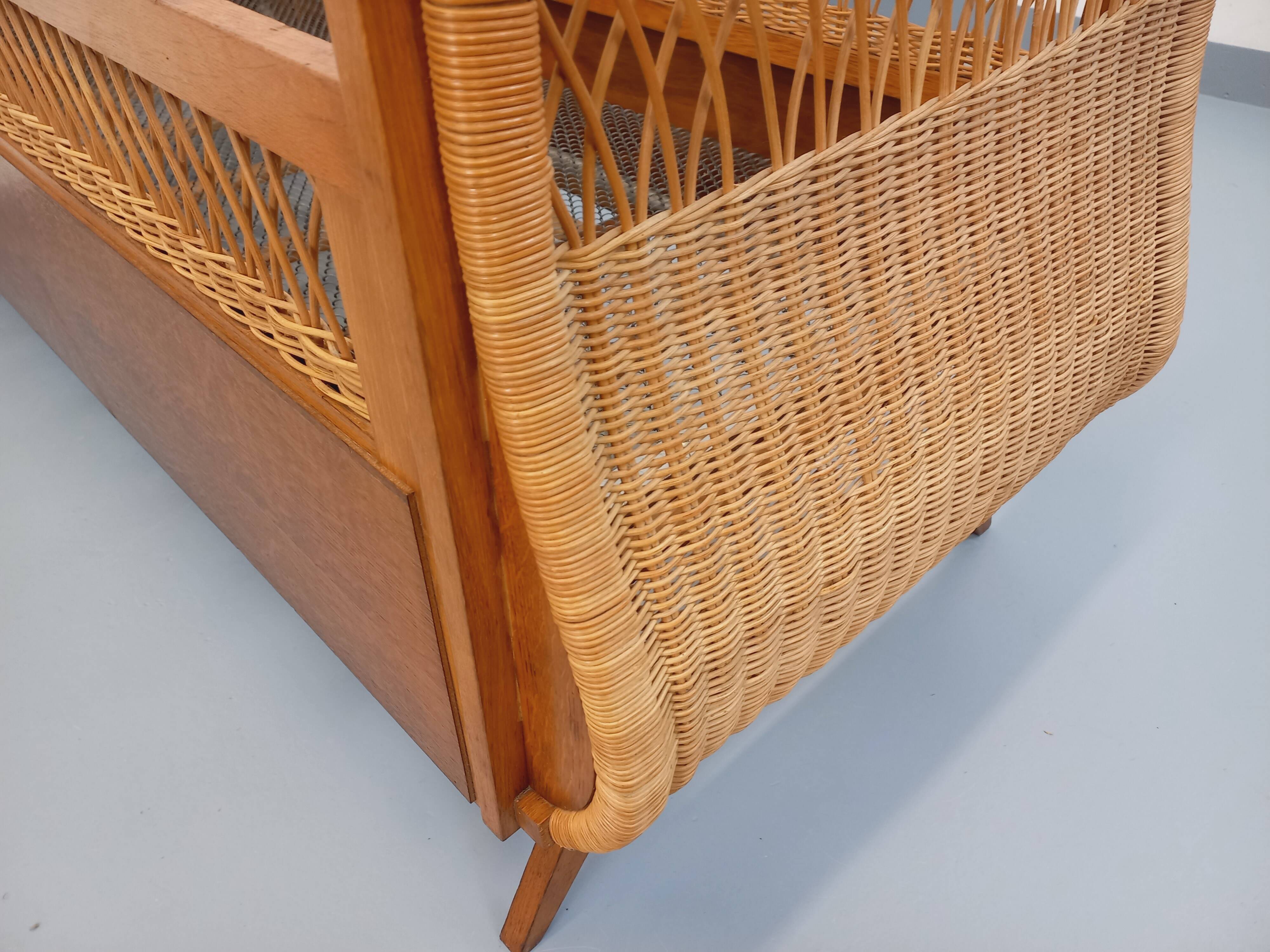 Vintage oak and rattan baby cot from the 1960s.