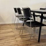 4 Spilimbergo chairs from Italy in chrome steel and black plastic.
