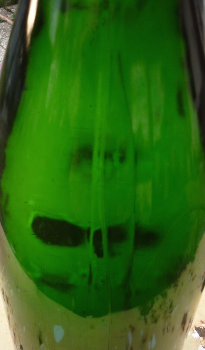 Green blown glass bottle of 58 cm.