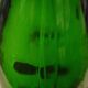 Green blown glass bottle of 58 cm.