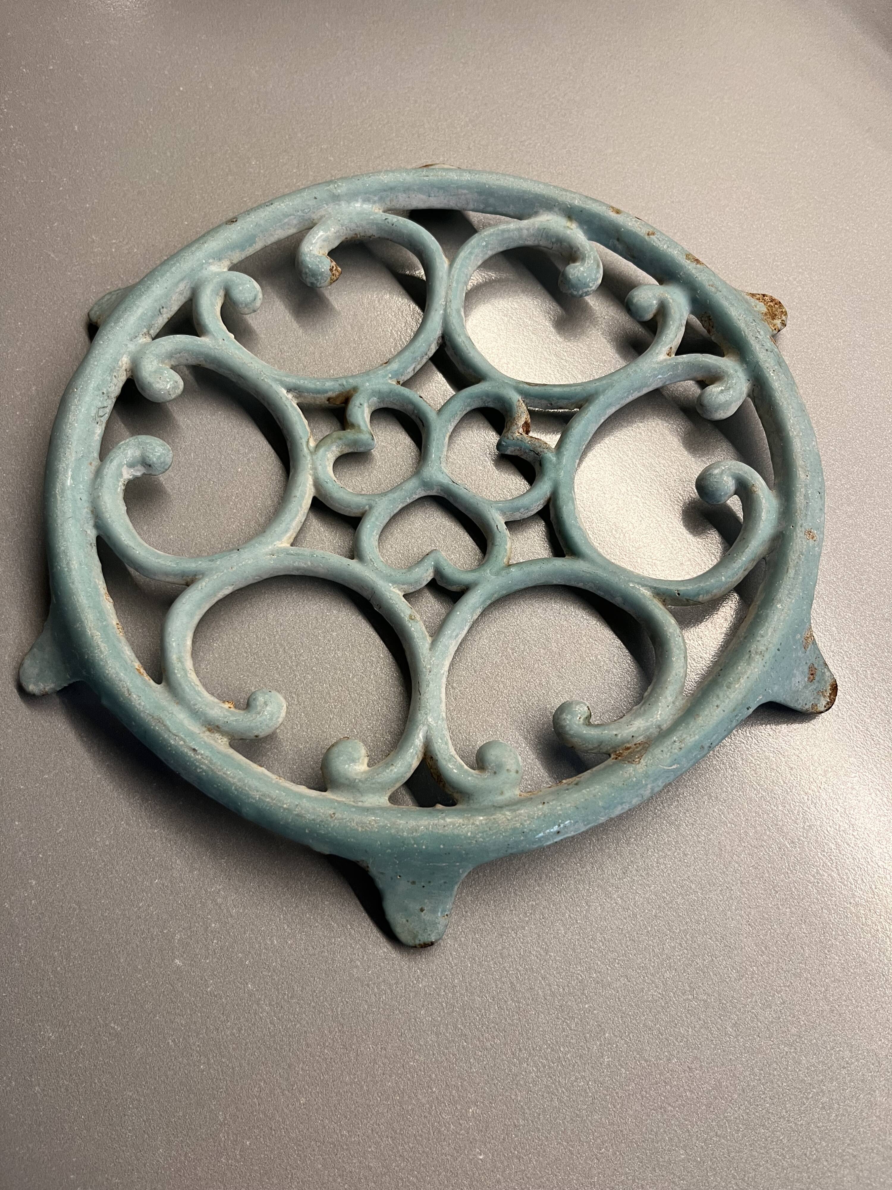 Old cast iron trivety turquoise