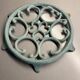 Old cast iron trivety turquoise