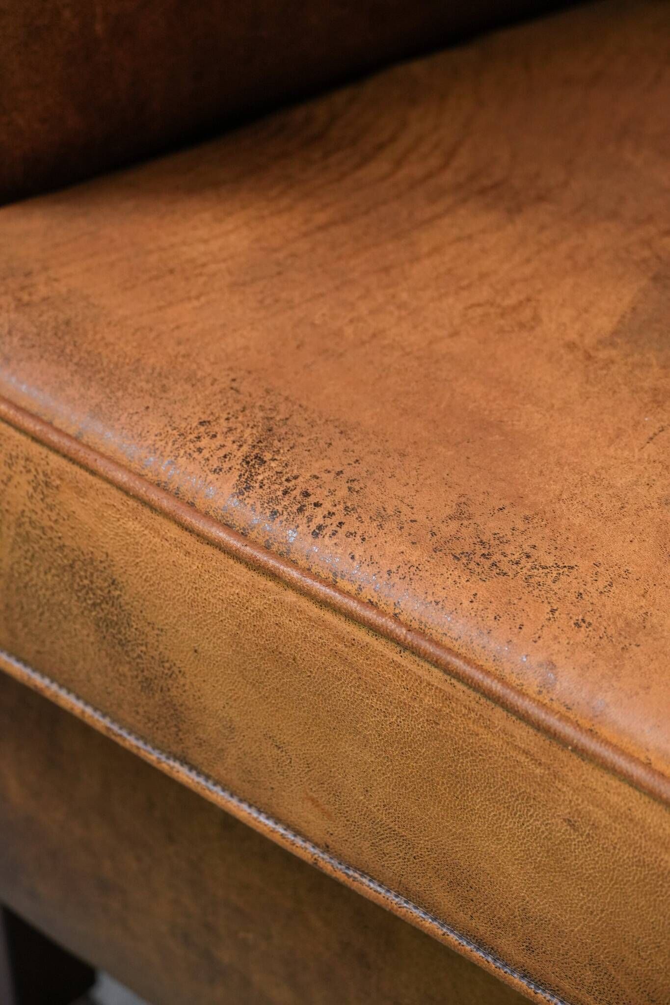 Vintage club chair in sheepskin leather with a characterful look