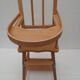 chaise haute de poupée à barreaux , bois clair