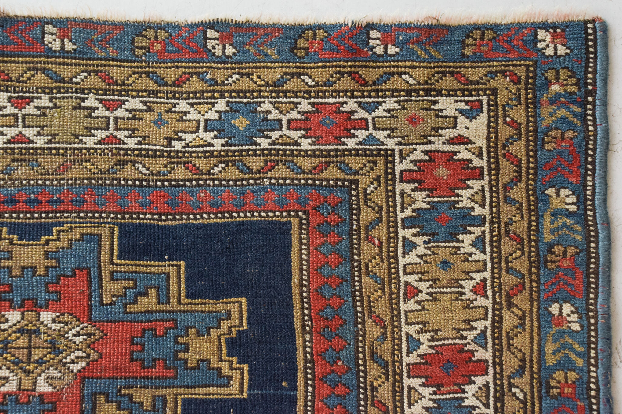 Handwoven blue ground persian rug with bird-like figures