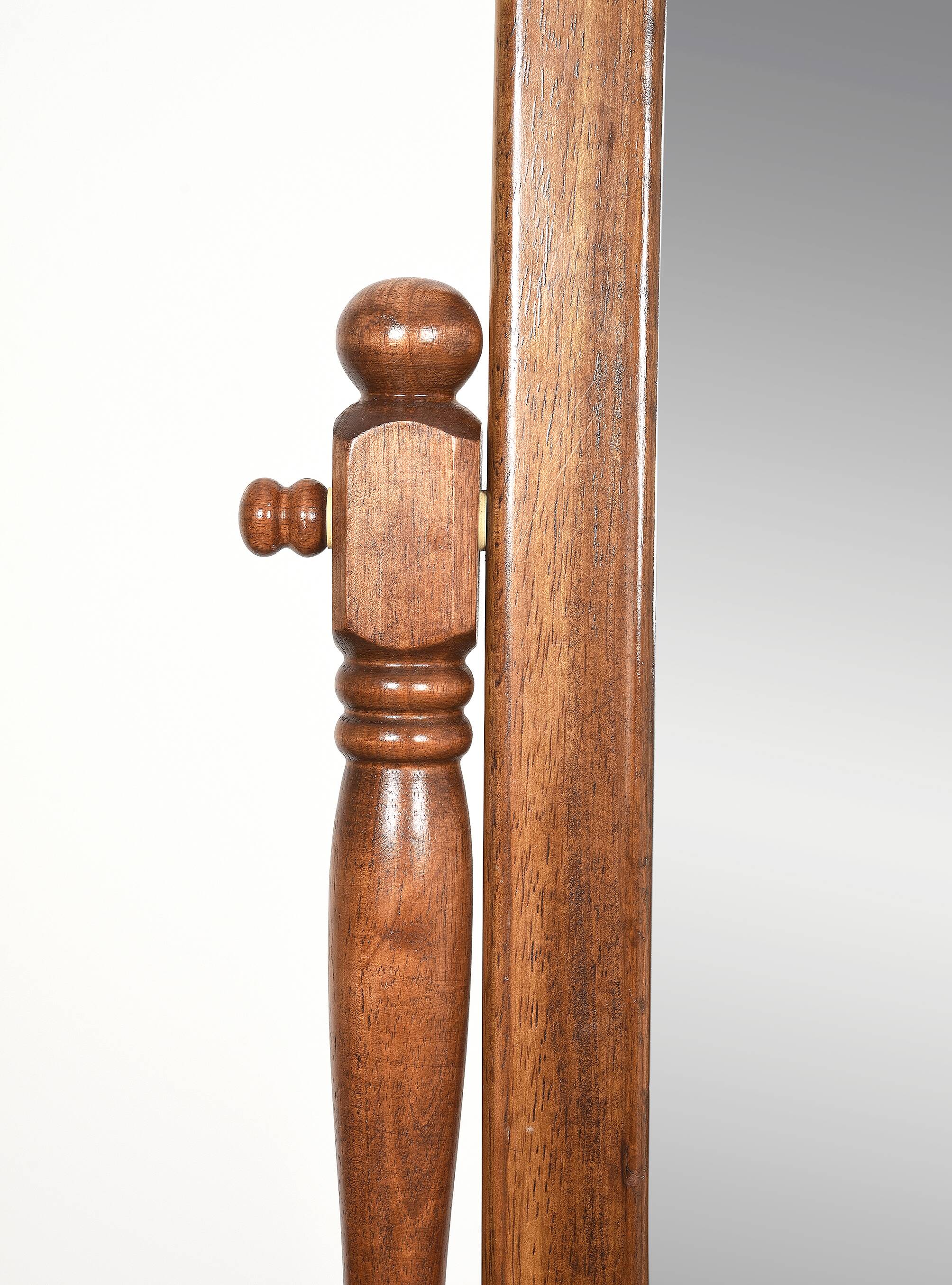 Large psychic mirror on legs with pivoting oval frame.