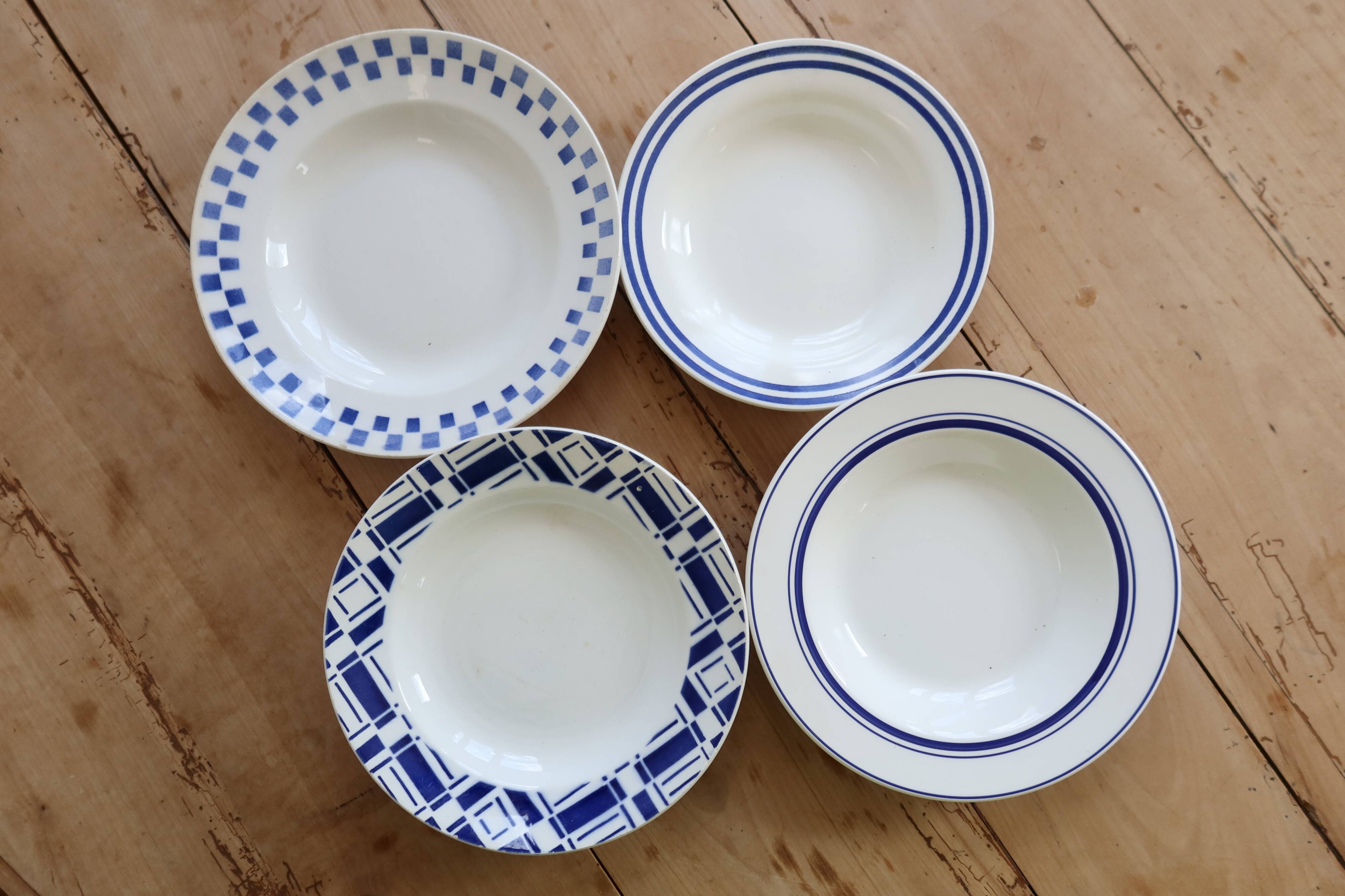 4 mismatched vintage deep plates in blue and white porcelain
