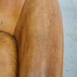 Comfortable, cozy, warm colored sheepskin club chair finished with decorative nails