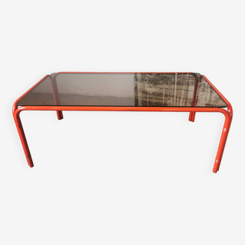 Table basse en verre fumé et  tubulure orangé des années 70 /80