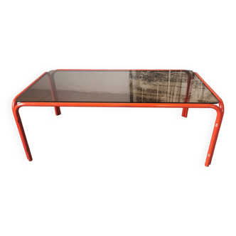 Table basse en verre fumé et  tubulure orangé des années 70 /80