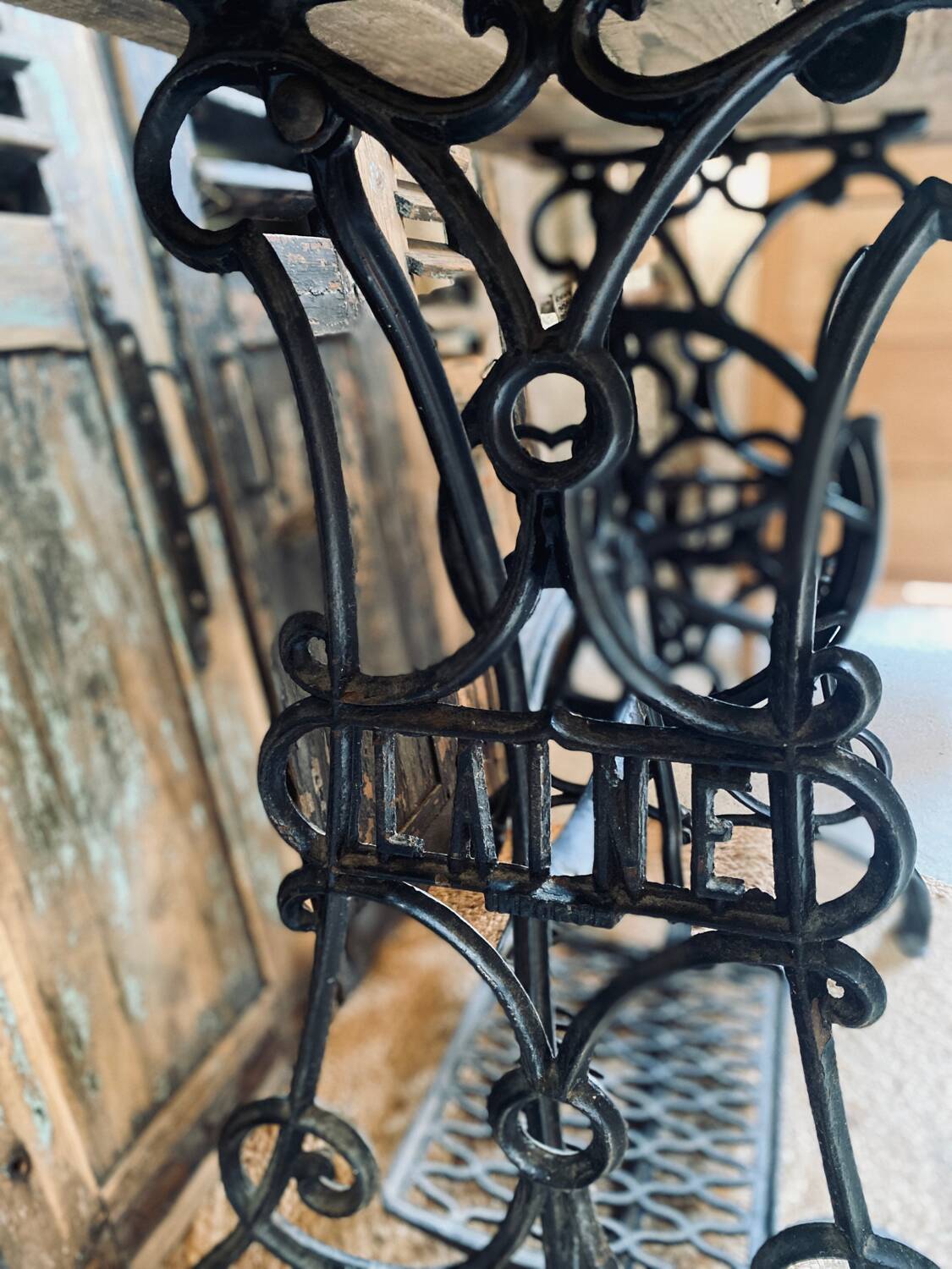 Vintage wooden table with a cast iron base.