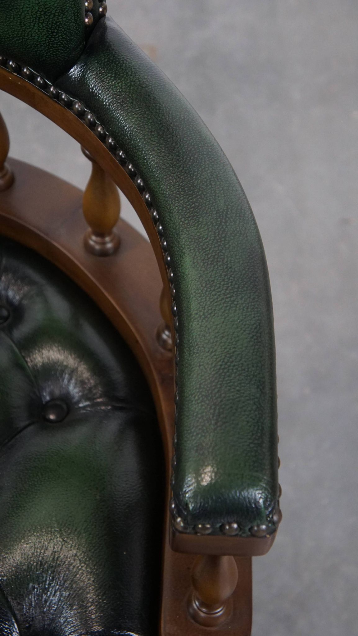 Dark green cowhide leather and wood chesterfield office chair on wheels