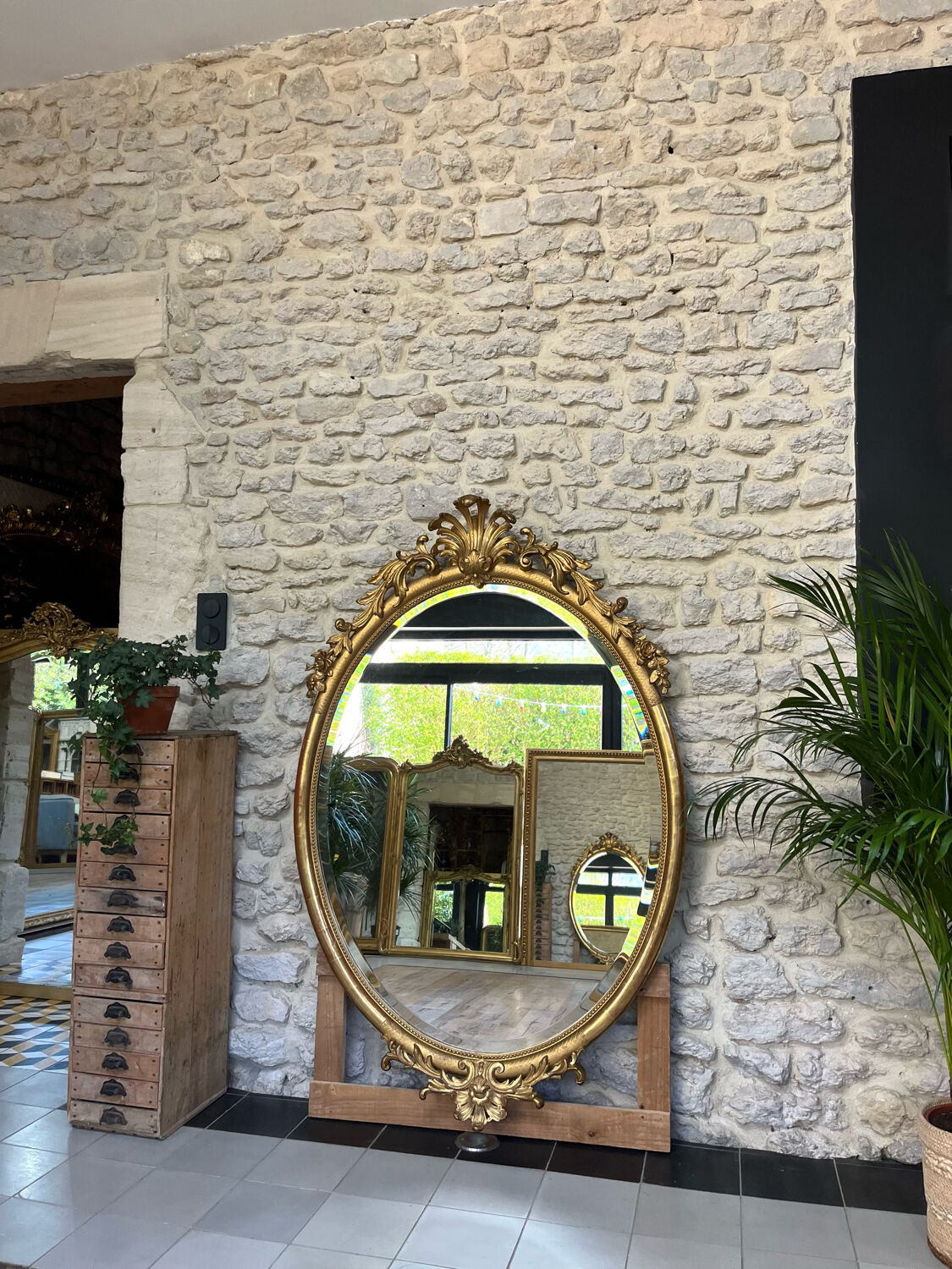 Oval mirror with pediment, beaded gilded with gold leaf