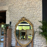 Oval mirror with pediment, beaded gilded with gold leaf