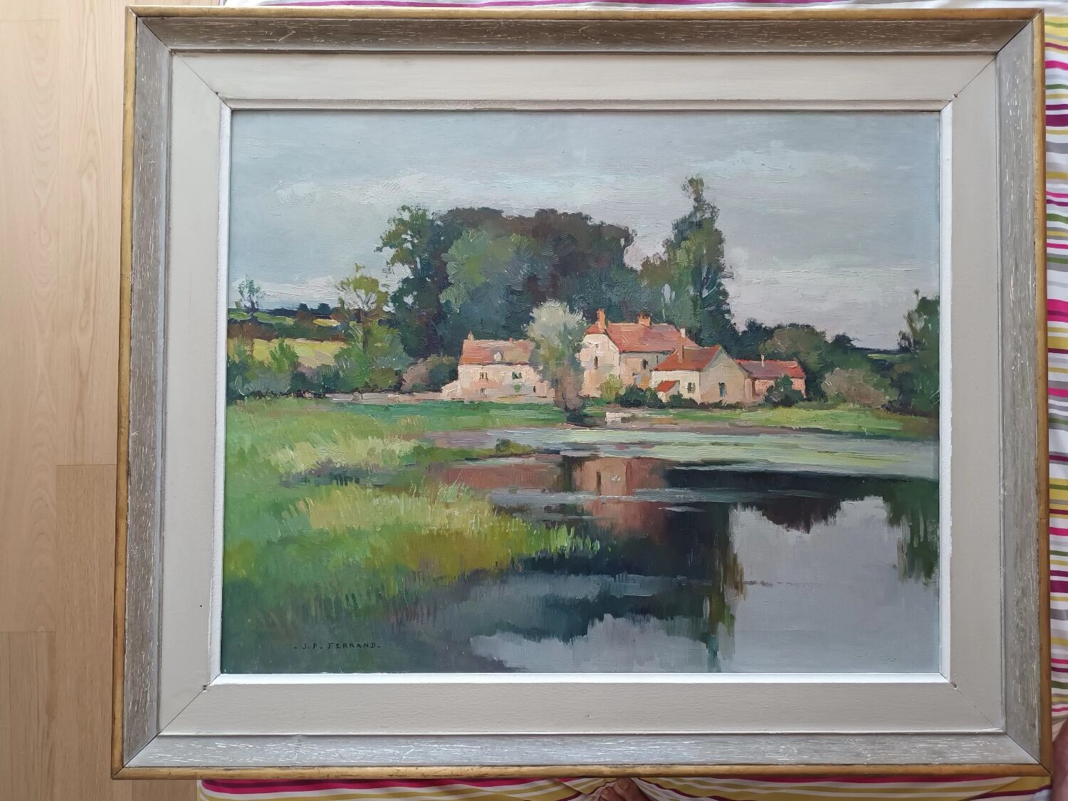 Oil on canvas by JP Ferrand: hamlet reflected in the pond