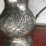 Tin pitcher decorating bunch of grapes