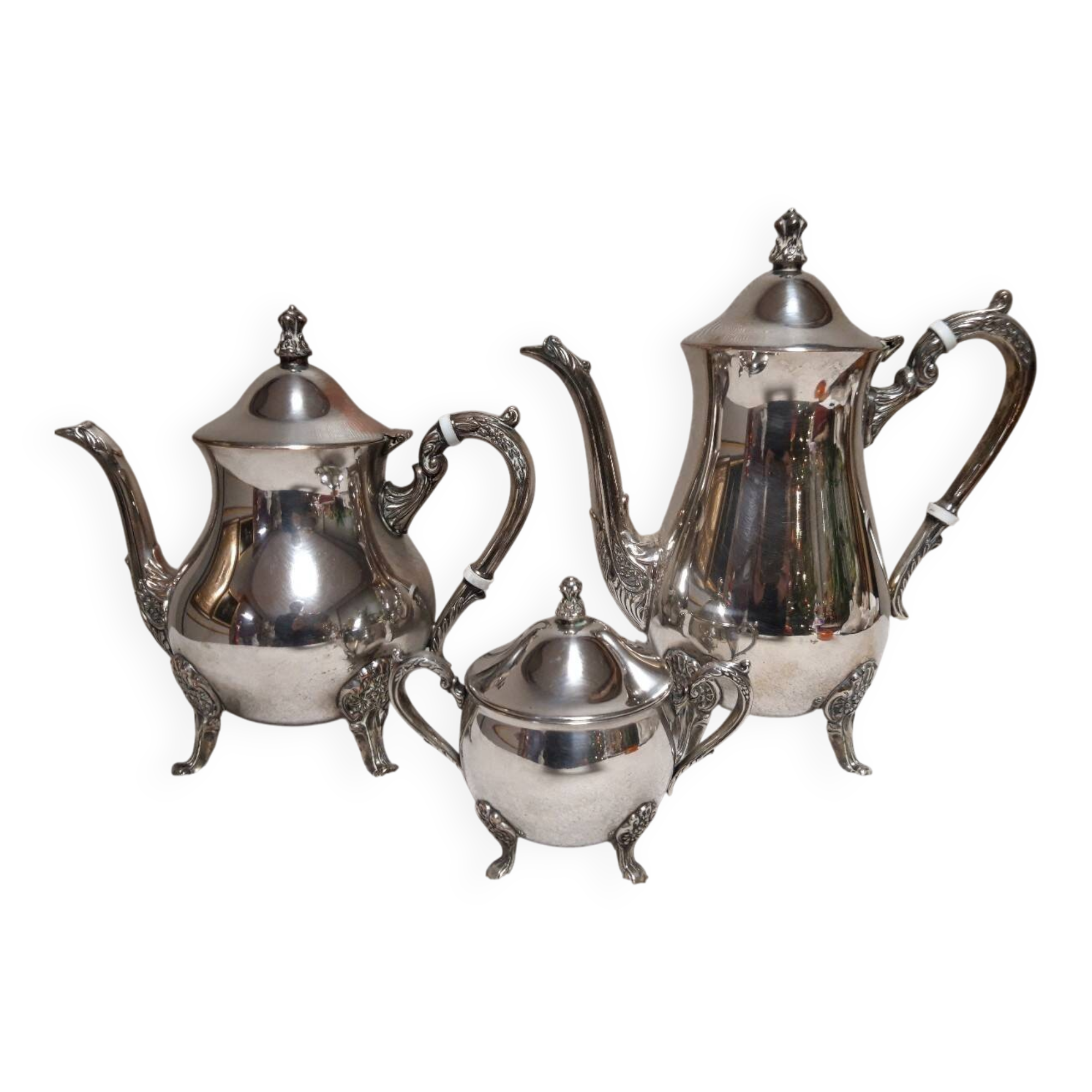 Silver-plated coffee and tea service including a coffee pot, a teapot, and a sugar bowl.