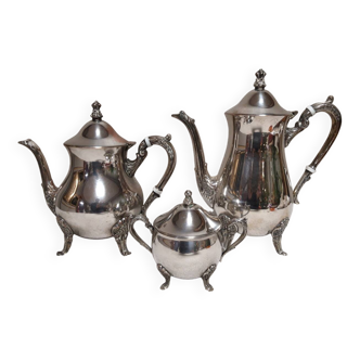 Silver-plated coffee and tea service including a coffee pot, a teapot, and a sugar bowl.