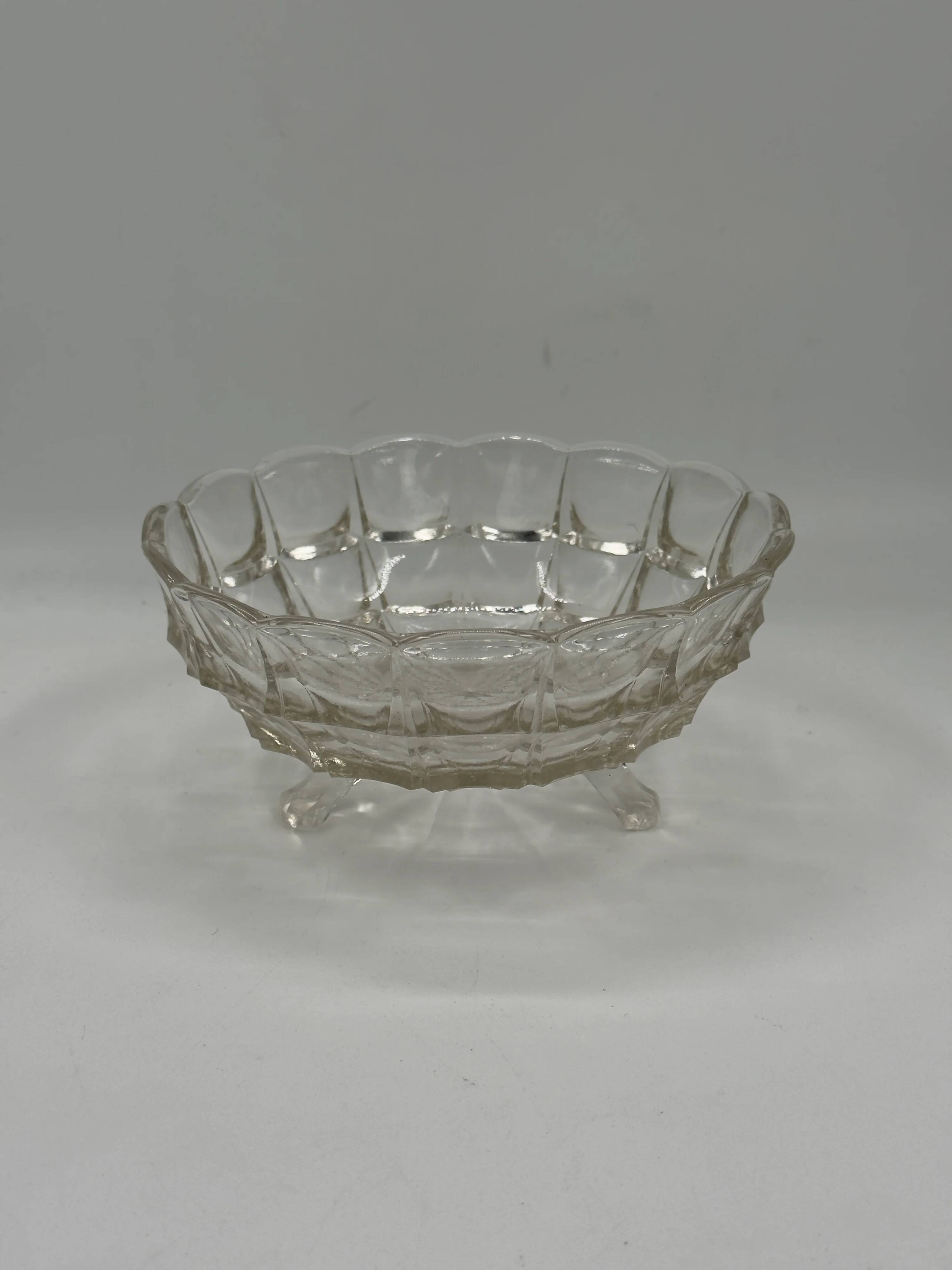 Vintage pressed glass footed coupe with scalloped diamond-cut edge.