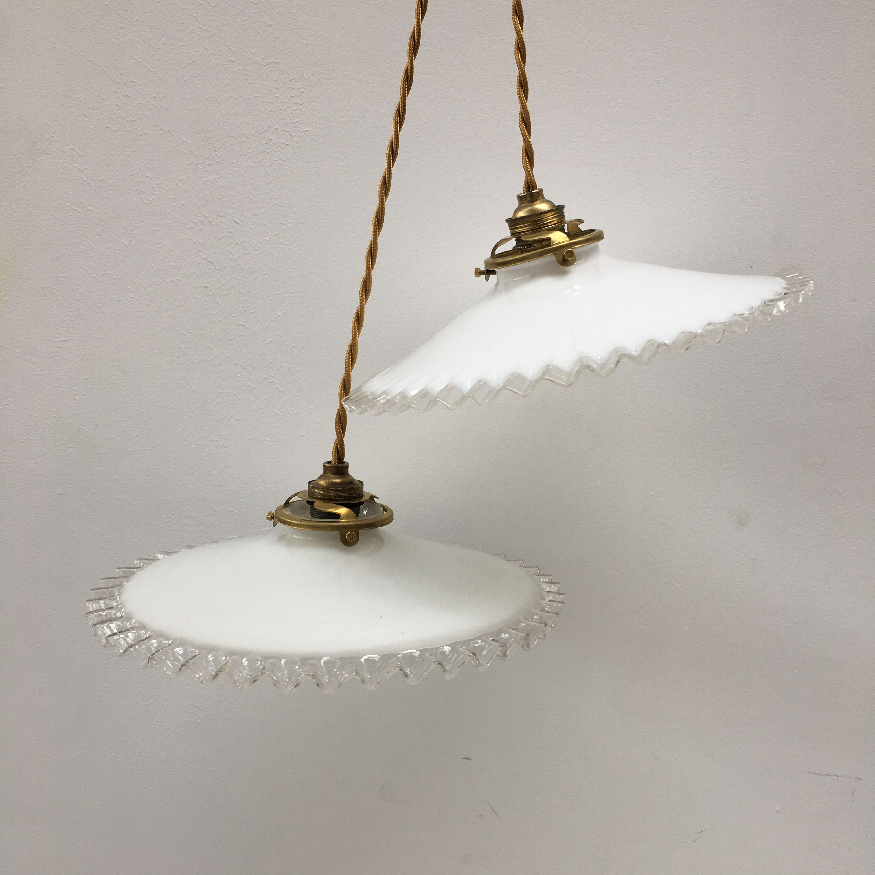 Pair of white opaline suspensions with serrated edges