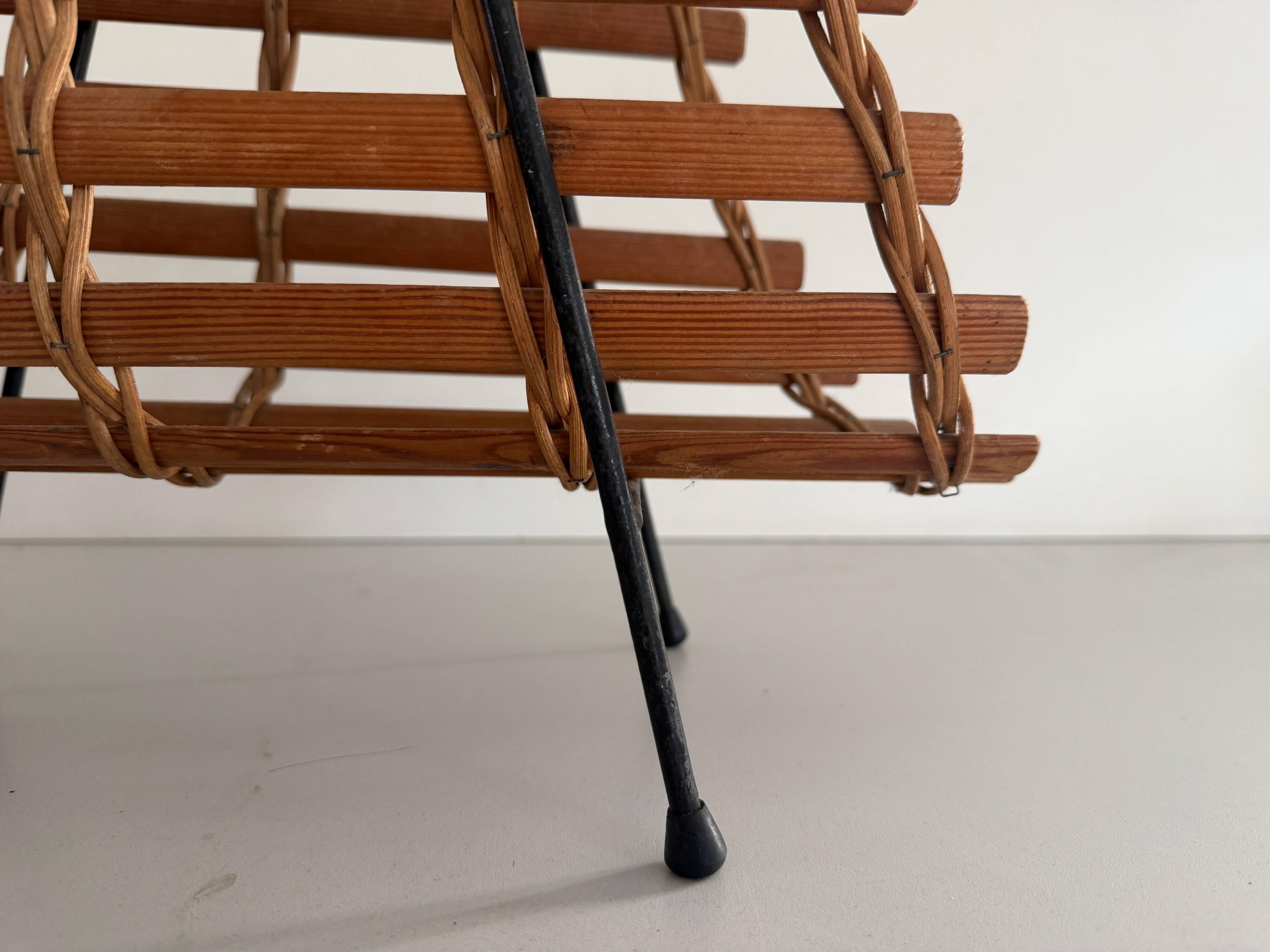 Mid-century black metal and wicker magazine rack, 1960, Germany