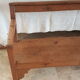 Church bench in fir tree with armrests