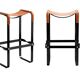 Pair of stools without a backrest in tobacco colour and black metal.