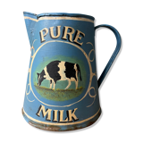 Old pitcher or milk jug in painted sheet metal