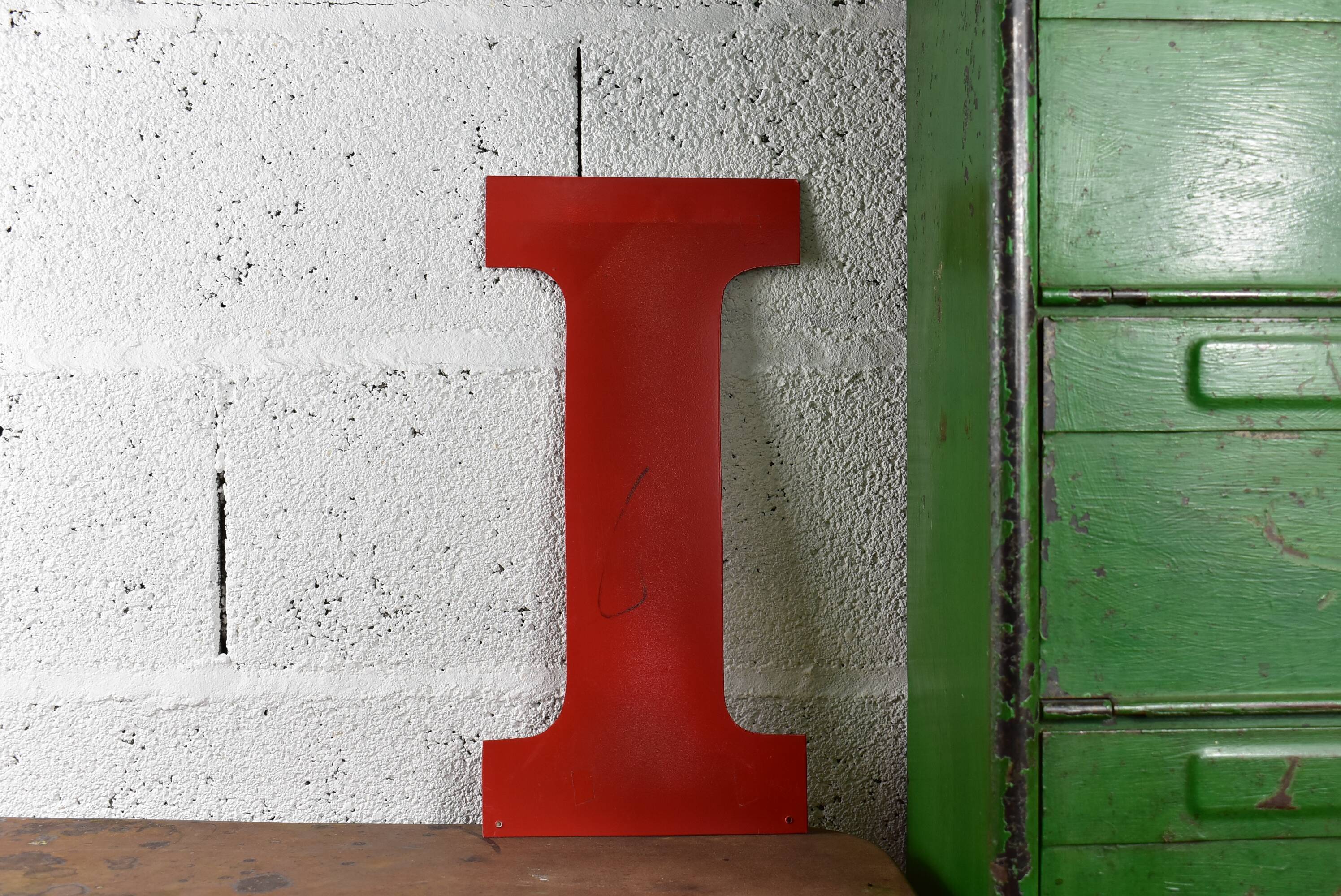 Industrial letter "I" in red metal