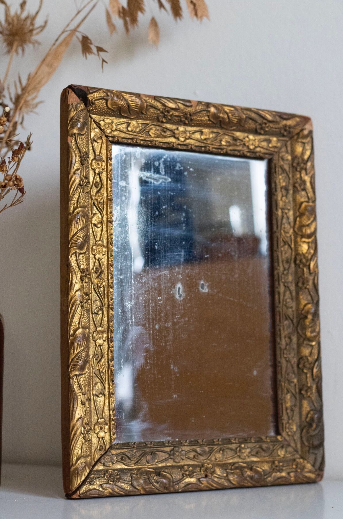 Antique mirror in gilded wood