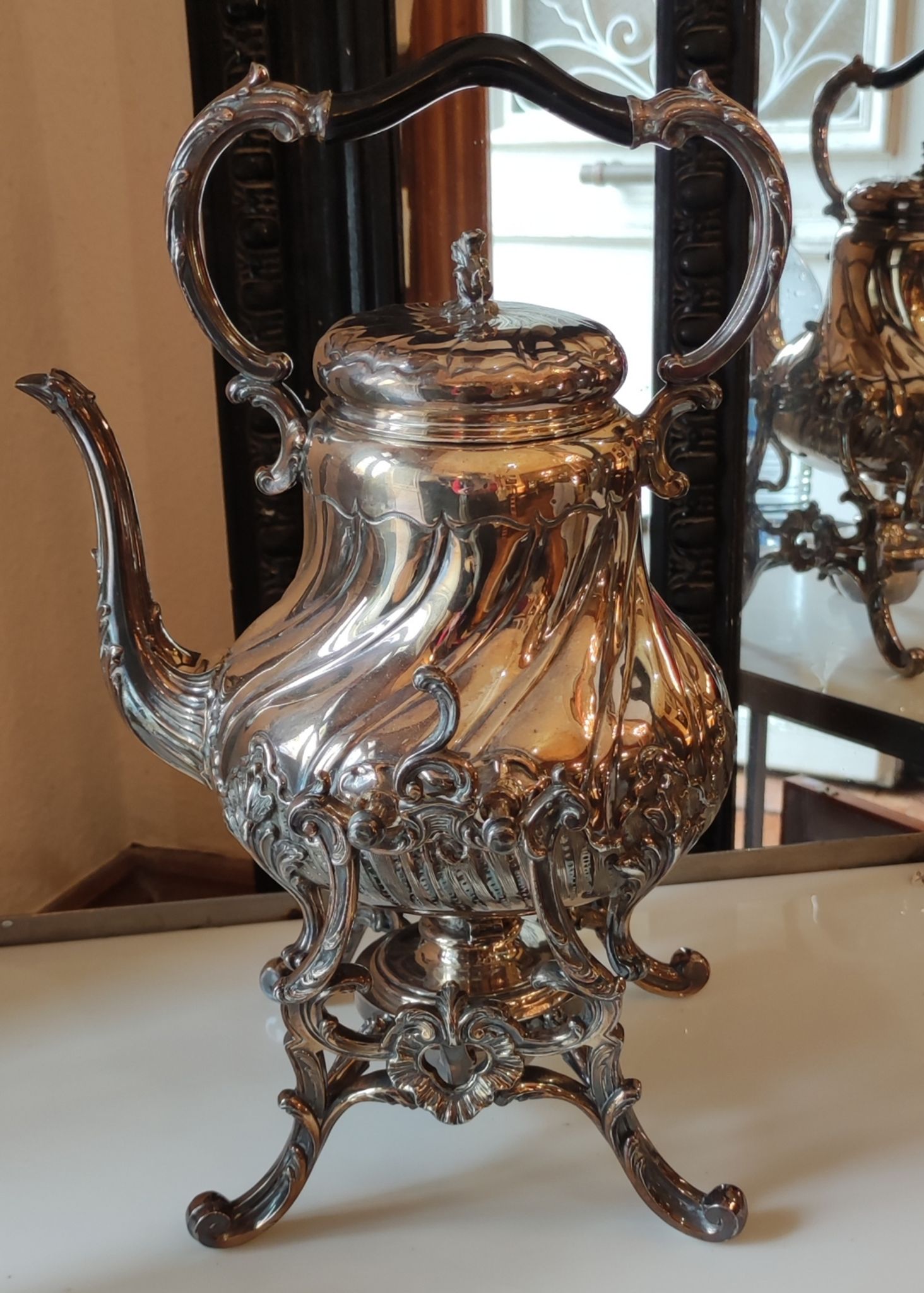 Ancient samovar tea fountain in silver metal