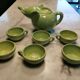 Handcrafted ceramic tea set with animal decoration.