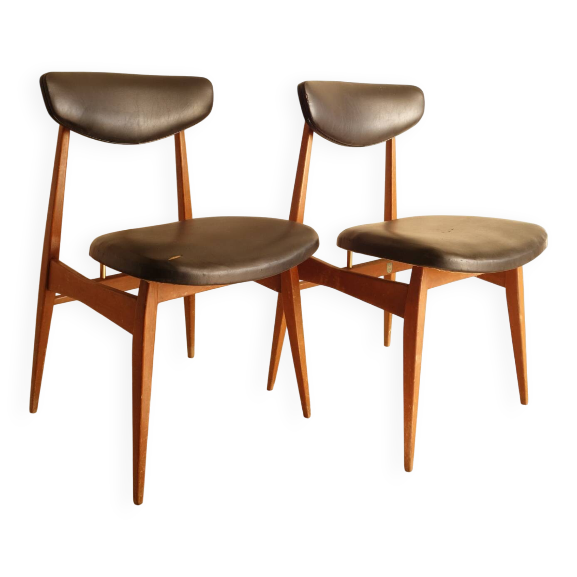 Pair of modernist Scandinavian chairs in teak and black faux leather.
