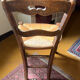 Old rustic wooden chair – carved backrest – seat in fibres