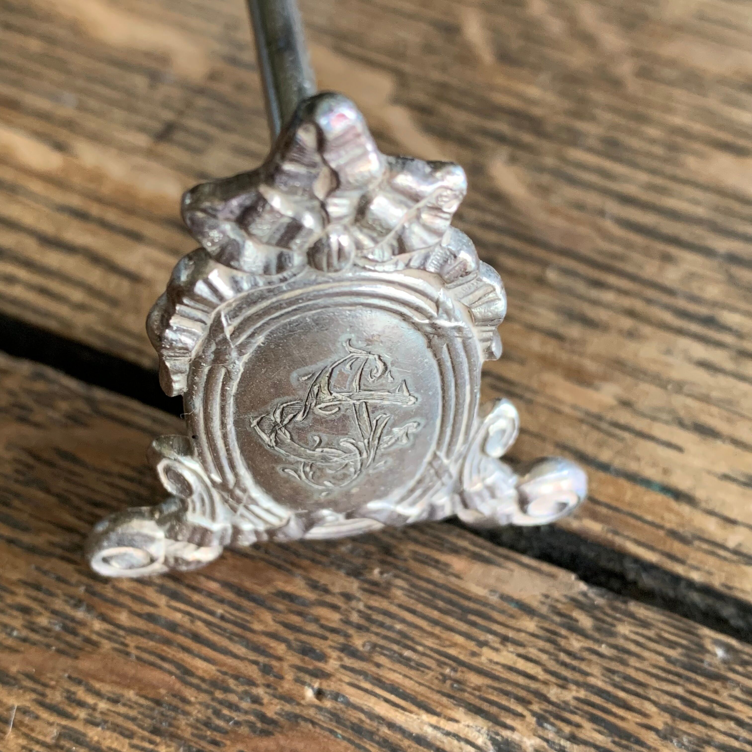 Series of 12 monogrammed silver metal knife holders