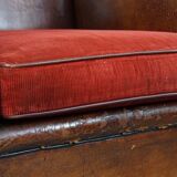 Sheepskin leather wingback chair with a red corduroy seat cushion