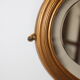 Beveled oval mirror in gilded wood