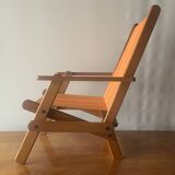 Old foldable beach seat in wood and canvas for children