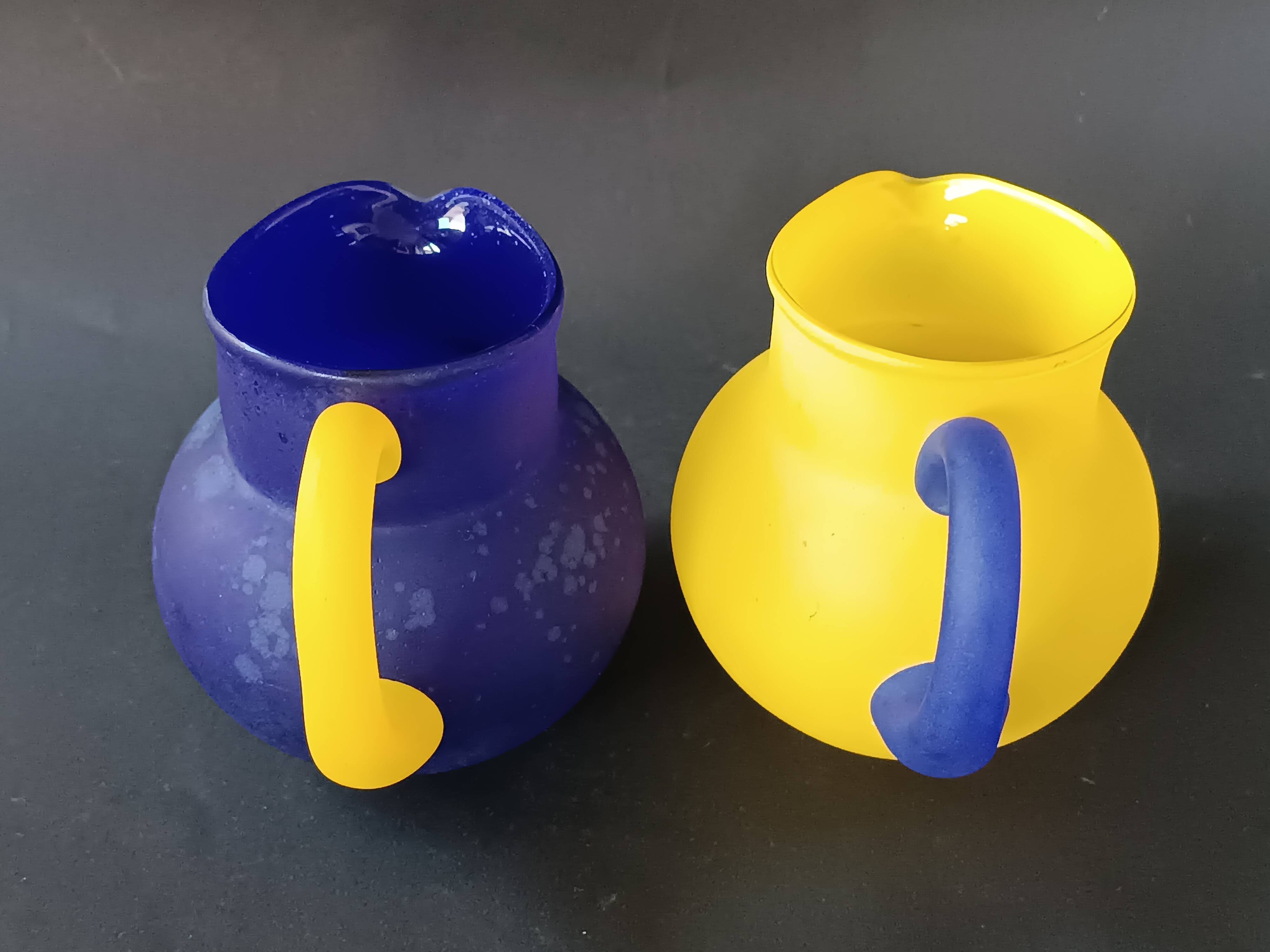 TWO VINTAGE YELLOW AND BLUE GLASS PITCHERS 1990