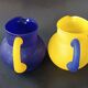 TWO VINTAGE YELLOW AND BLUE GLASS PITCHERS 1990