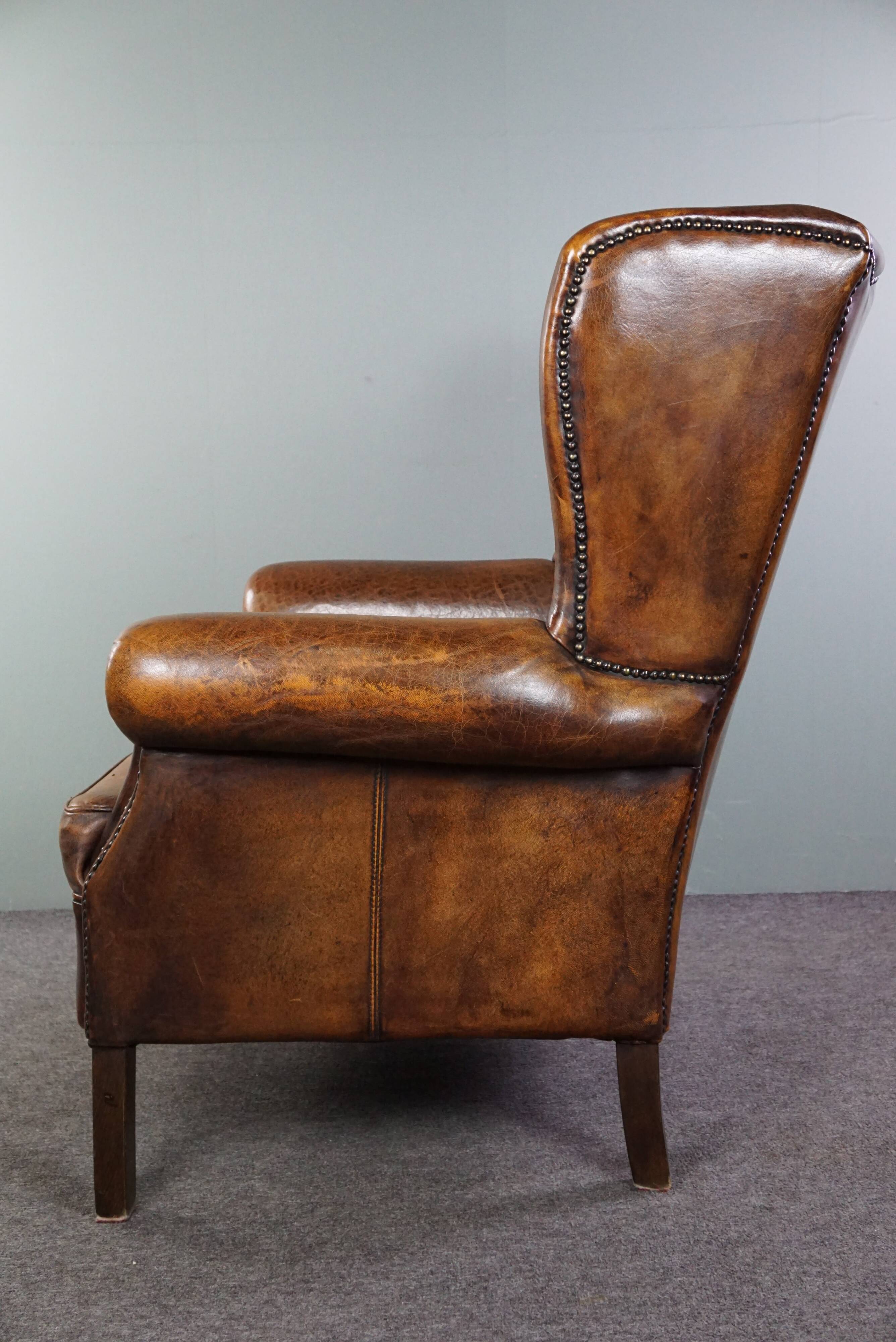 Dark wingback armchair made of sheep leather with stunning colors