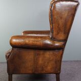 Dark wingback armchair made of sheep leather with stunning colors