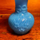 Blue opaline vase, opaque glass, wavy neck/rim, relief decoration of a bow.