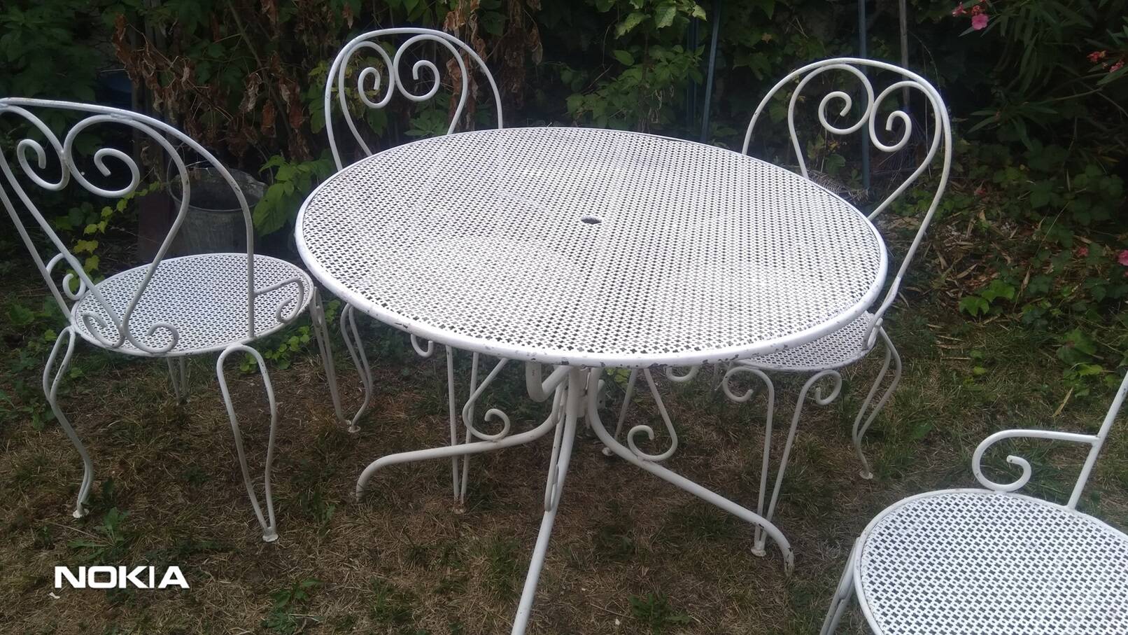 Mategot-style perforated wrought iron garden furniture with table and armchairs